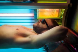 Man tanning in a MegaSun bed