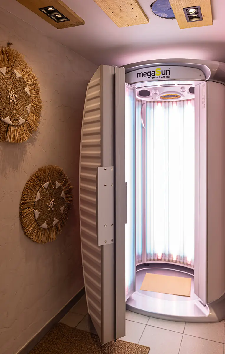 Luxury indoor tanning room with MegaSun solarium equipment and relaxation seating